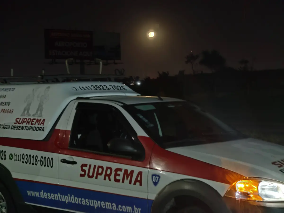 Picape da Suprema Desentupidora estacionada à noite durante plantão 24 horas
