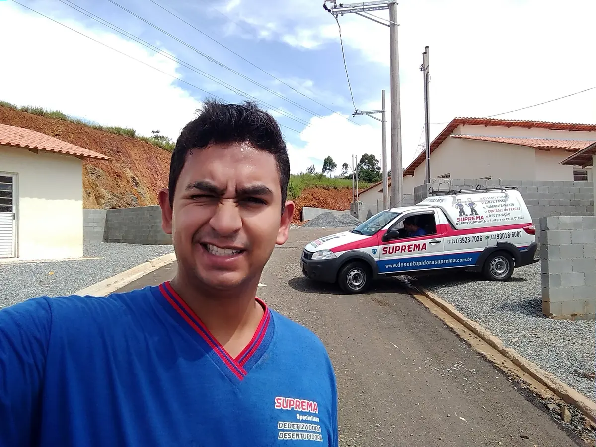 Técnico da Suprema Desentupidora com a picape da empresa em condomínio de casas